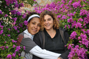 Two females surrounded by purple flowers
